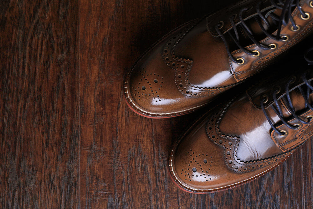 A pair of luxury Cordovan Shoes close up on wood background.